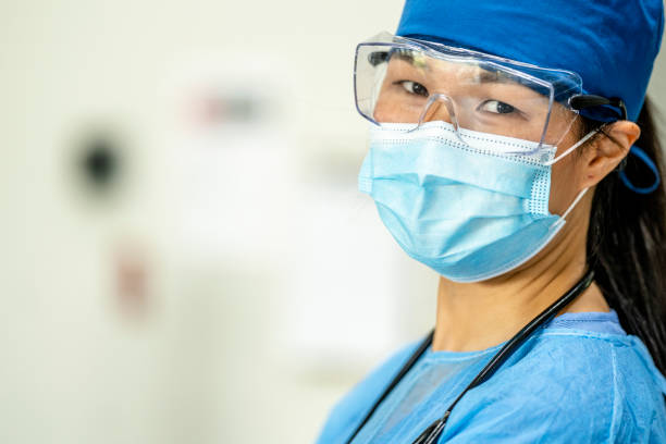 istock Female medical professional wearing PPE (personal protective equipment) 1255911551