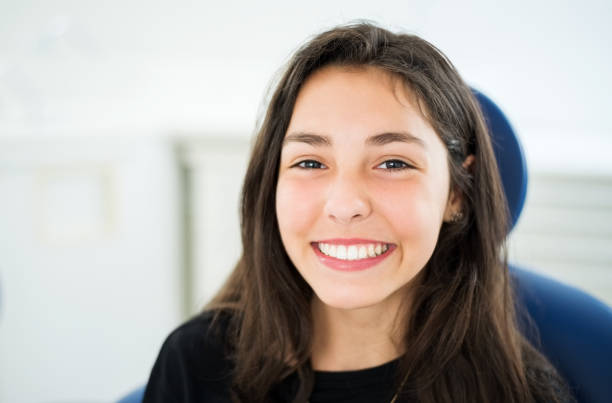 Confident smile after dental treatment Close-up portrait of a beautiful girl with a beautiful toothy smile sitting at dental clinic cute 15 year old girls stock pictures, royalty-free photos & images