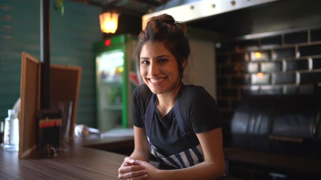 Portrait of a waitress behind the counter