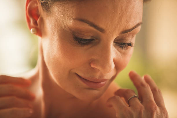 istock Woman looking down at her shoulder 1255913510
