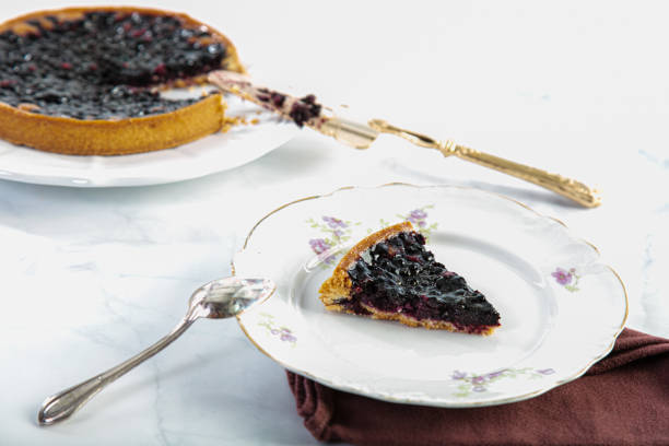 istock Cut blueberry tart with a cake slice 1255916003