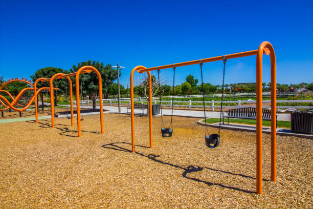 istock Kid's Swing Sets At Free Public Park 1255916312