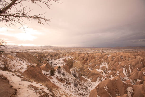 Fairy Chimneys covered with snow near Uchisar, cave castle, Cappadocia,