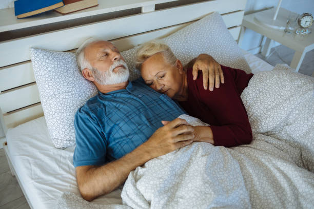 istock Senior couple sleeping in bed 1255917688