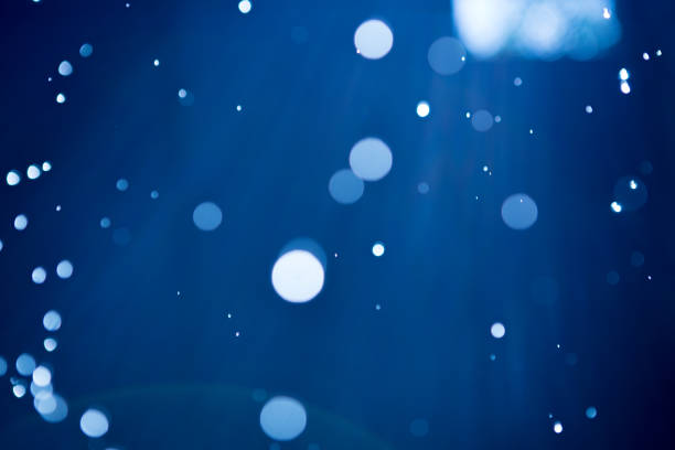 istock Abstract background with highlights and bokeh from splashing water, light from lanterns and sun 1255917704