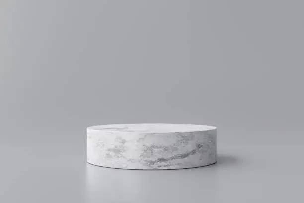 Photo of White marble product display on gray background with modern backdrops studio. Empty pedestal or podium platform. 3D Rendering.