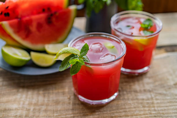 istock Watermelon smoothie lemonade with lime, topping with fresh mint leaves for the summer drinks concept. Homemade refreshing cold drink 1255920230