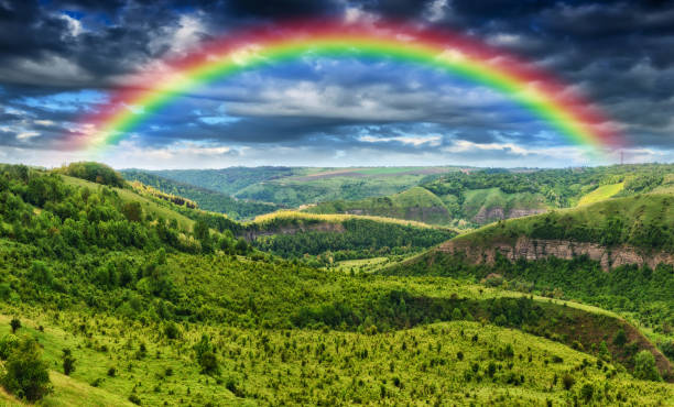 istock Beautiful landscape with a rainbow in the sky 1255920246