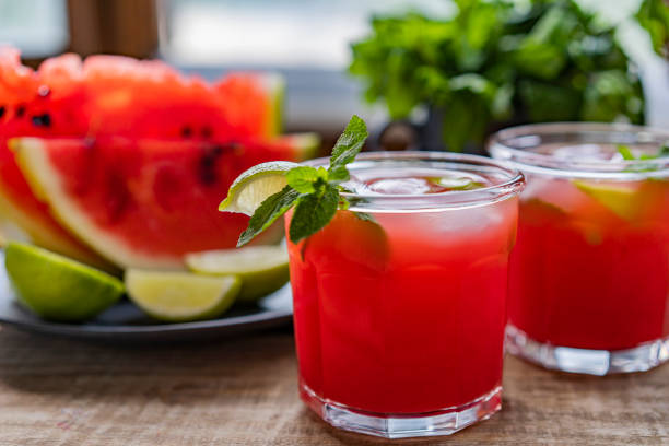 istock Watermelon smoothie lemonade with lime, topping with fresh mint leaves for the summer drinks concept. Homemade refreshing cold drink 1255920276