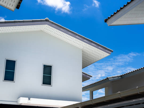 istock Simple white house on blue sky and clouds background. 1255922662