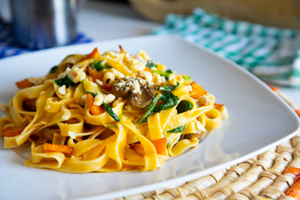 istock Vegan pasta with spinach, nuts and tomato sauce 1255922998