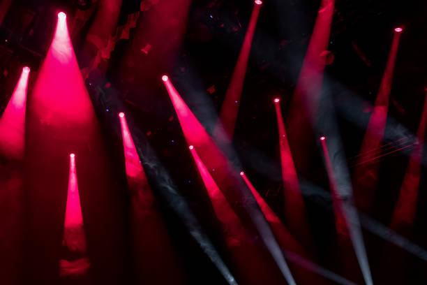 istock Pink spotlights with smoky air on the stage as background 1255924780