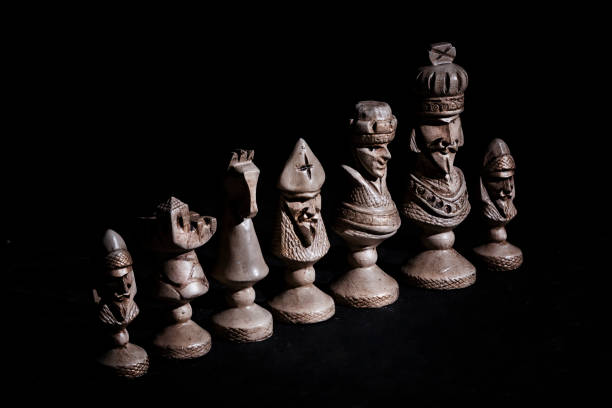istock chess pieces in a row on a black background 1255924910