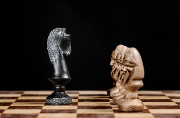 istock pawn chess pieces facing the knight on a chessboard 1255924915