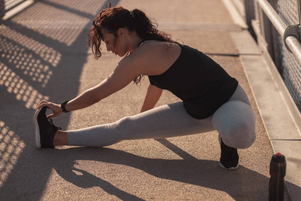 istock Young woman doing a leg stretching exercise 1255927862