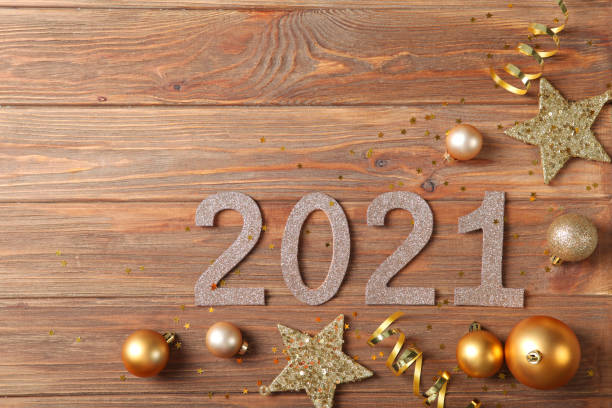 istock Composition with numbers 2021 and Christmas decor on a colored background top view 1255927877
