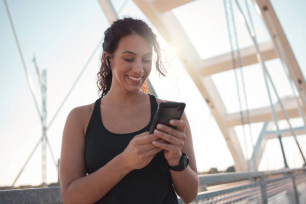 istock Fitness woman using smart phone 1255929442