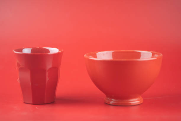 istock Colour red of bowl and cup on red background 1255931969