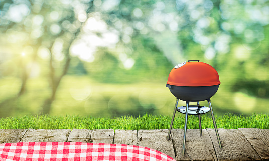barbecue grill on backyard and wooden table
