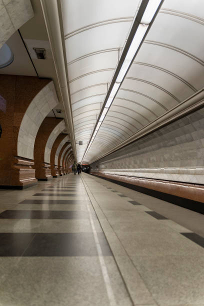 istock Empty metro station, lonely people on long platform. 1255935551
