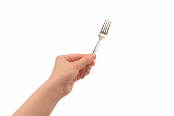 istock Fork in woman hand isolated on white. 1255937768