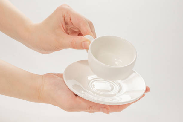 istock Empty coffee cup in woman hand isolated on white. 1255937770