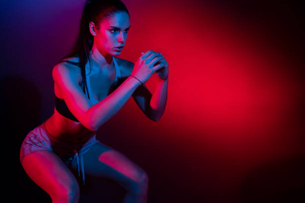 istock Young sportswoman doing squats 1255941235