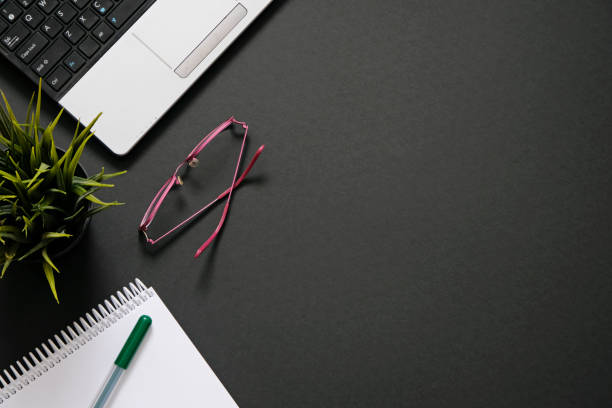 istock Flat lay with office supplies, computer and plant with copy space 1255941751