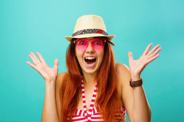 istock Woman wearing a swimsuit and hat smiling 1255943112