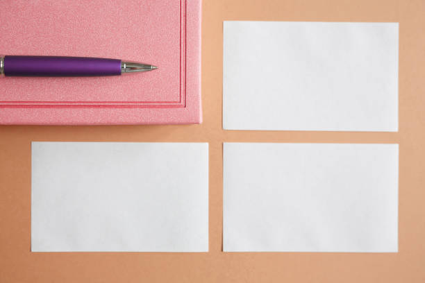 istock business card, diary and pen on a brown background 1255944926