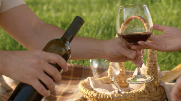 istock Male hand pouring wine into a wineglass 1255944983