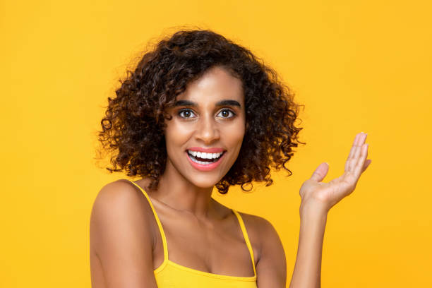 istock Smiling attractive African American woman with one hand raised looking in camera 1255946151