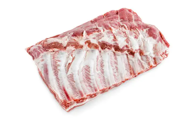 Photo of Raw pork ribs. Raw meat, farm and cooking concept. Meat shop. Whole raw pork ribs isolated on white background