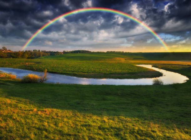 istock Landscape with a Rainbow on the River in Spring 1255946727