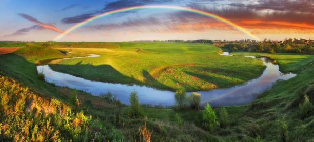 istock Landscape with a Rainbow on the River in Spring 1255946729