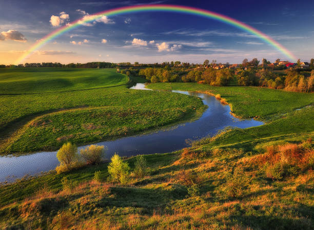 istock Landscape with a Rainbow on the River in Spring 1255946903