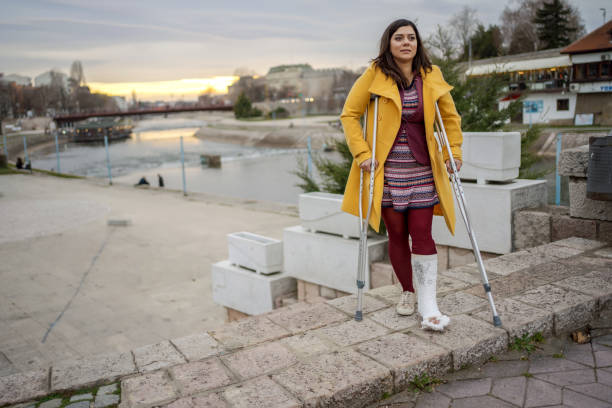 istock Woman walking with cast on foot 1255947600