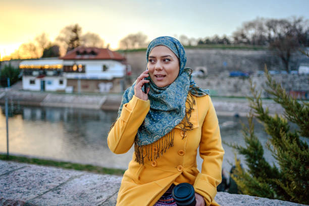 istock Young Muslim woman talking on phone 1255948200
