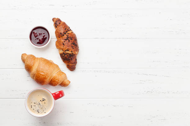 istock Breakfast with coffee and croissants 1255948352
