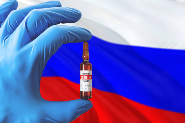 Russia flag with Coronavirus Covid-19 concept. Doctor with blue protection medical gloves holding a vaccine bottle. Epidemic Virus, Cov-19, Corona virus outbreaking. Russia flag with Coronavirus Covid-19 concept. Doctor with blue protection medical gloves holding a vaccine bottle. Epidemic Virus, Cov-19, Corona virus outbreaking. russian culture photos stock pictures, royalty-free photos & images