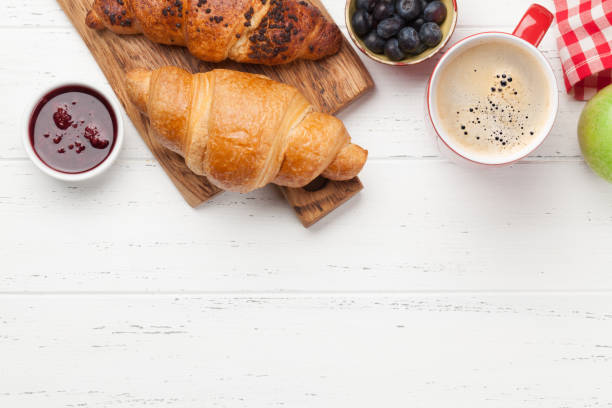 istock Breakfast with coffee and croissants 1255948410