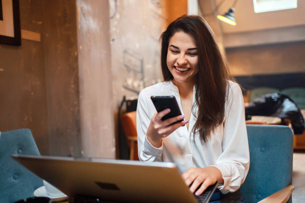 istock Business woman at a cafe texting message 1255948915