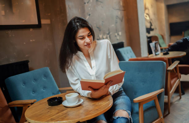 istock Beautiful woman reading romantic literature 1255948974