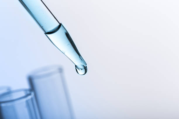 istock pipette with a drop and scientific laboratory test tubes in a research laboratory. study of a virus or vaccination. 1255949695