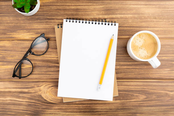istock Notebook with pencil, plant, glasses and coffee. 1255950766