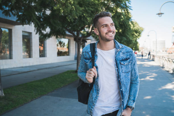 istock Man walking on the street. 1255951910