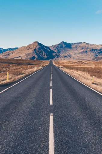 icelandic straight road forward to the mountains.