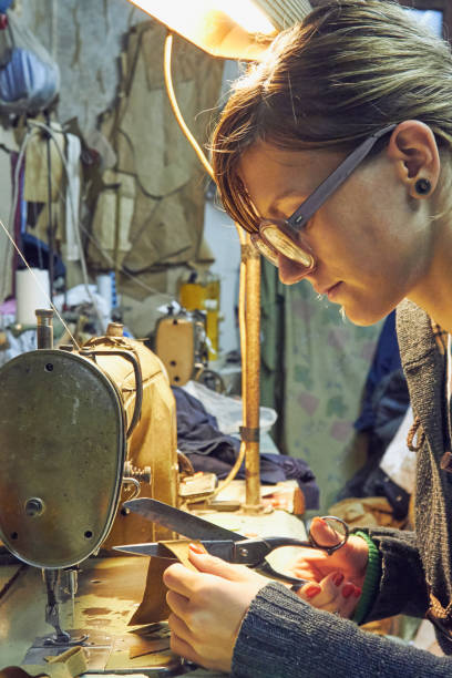 istock Woman tailor using retro sewing machine at home, hobby concept. 1255952811