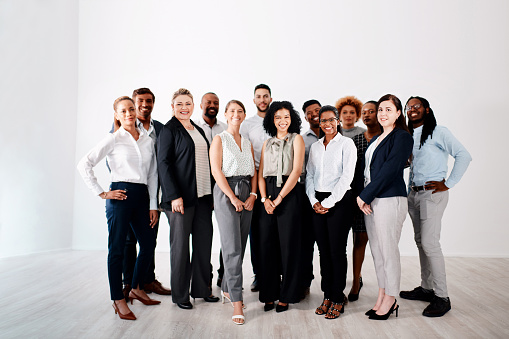 Studio portrait of a group of businesspeople standing together against a white background