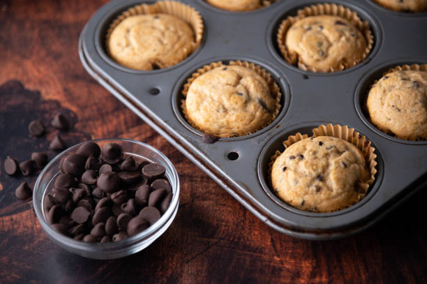 istock chocolate chip muffin on dark wooden board 1255954391
